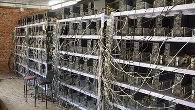 A modern mining farm with rows of ASICs.